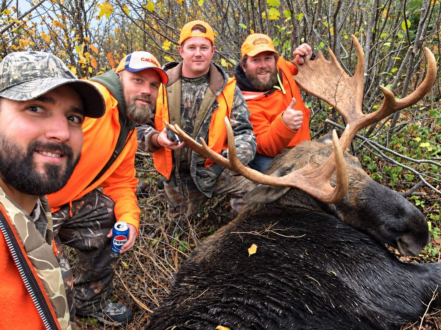 Successful hunting group with their moose
